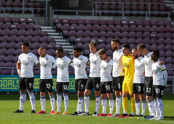 Posh players observe a minute's silence for Tommy Robson before the match at Northampton Town. Photo: Joe Dent/theposh.com.