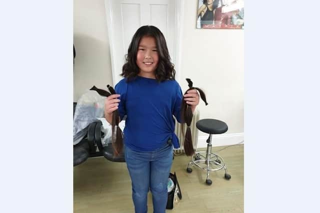 Aimee Lee with the hair she has donated to the Little Princess Trust
