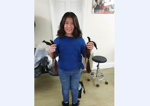 Aimee Lee with the hair she has donated to the Little Princess Trust