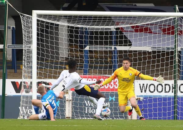 Christy Pym of Peterborough United makes a save from Daniel Agyei of Oxford United. Photo: Joe Dent/theposh.com.