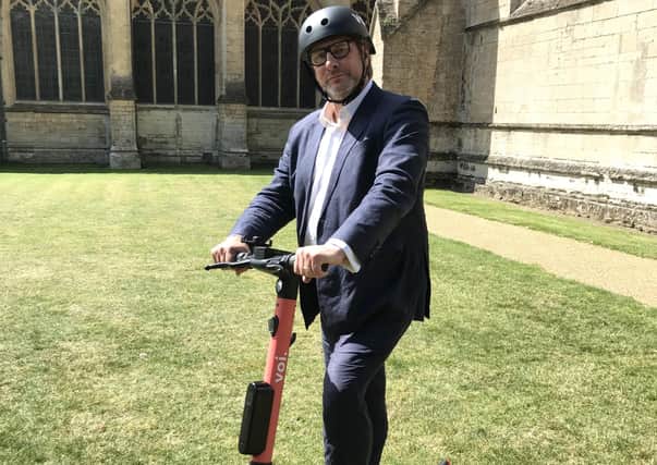 Mayor James Palmer tries out an E-scooter in Cambridge.