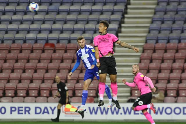 Jonson Clarke-Harris of Peterborough United out jumps Tom James of Wigan Athletic. Photo: Joe Dent/theposh.com