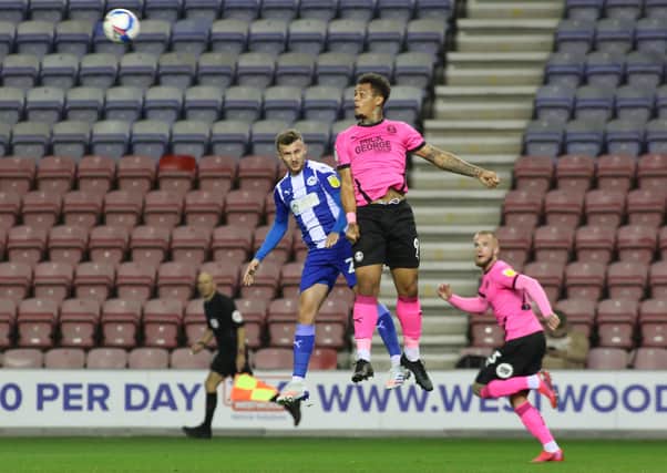 Jonson Clarke-Harris of Peterborough United out jumps Tom James of Wigan Athletic. Photo: Joe Dent/theposh.com