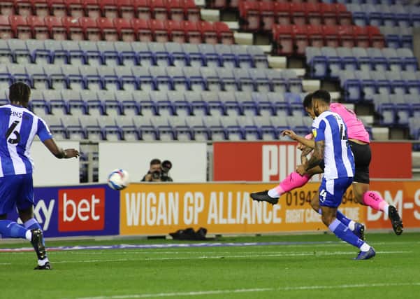 Jonson Clarke-Harris of Peterborough United scores the opening goal against Wigan Athletic. Photo: Joe Dent/theposh.com