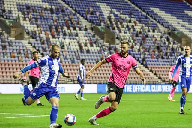 Posh skipper Mark Beevers closes down Joe Garner of Wigan Athletic. Photo: Joe Dent/theposh.com.