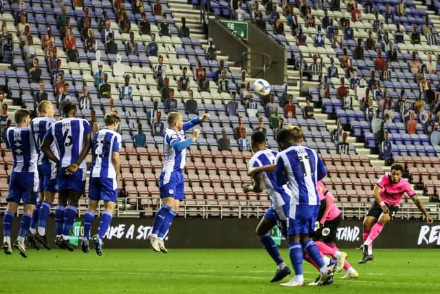 Posh matchwinner Jonson Clarke-Harris shoots at goal direct from a free-kick at Wigan.