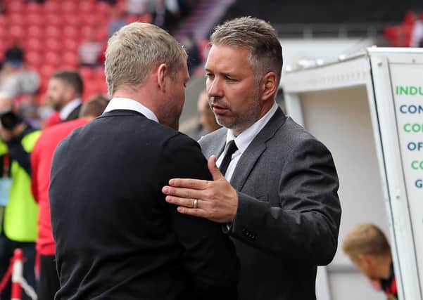 Doncaster Rovers manager Darren Ferguson shakes hands with Peterborough United manager Grant McCann before a League One game in September, 2017.