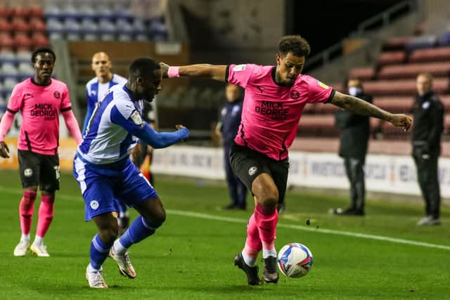 Jonson Clarke-Harris (right) in action for Posh at Wigan on Tuesday. Photo: Joe Dent/theposh.com.