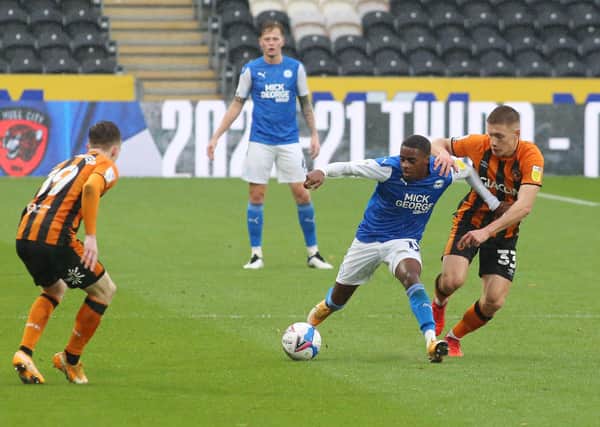 Reece Brown of Peterborough United in action with Greg Docherty of Hull City. Photo: Joe Dent/theposh.com.