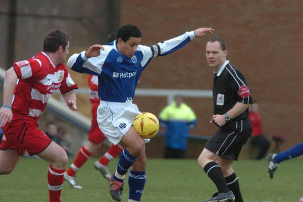 Curtis Woodhouse (blue) in action for Posh.