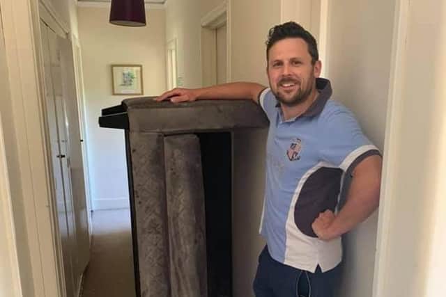 Luke Shepperson with the sofa donation