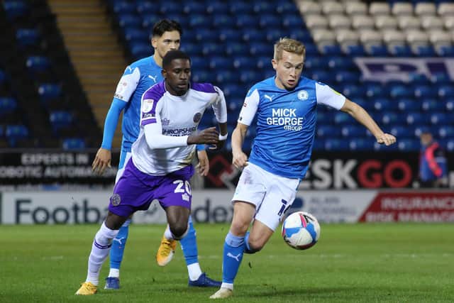 Louis Reed of Peterborough United in action with Shilow Tracey of Shrewsbury Town. Photo: Joe Dent/theposh.com.