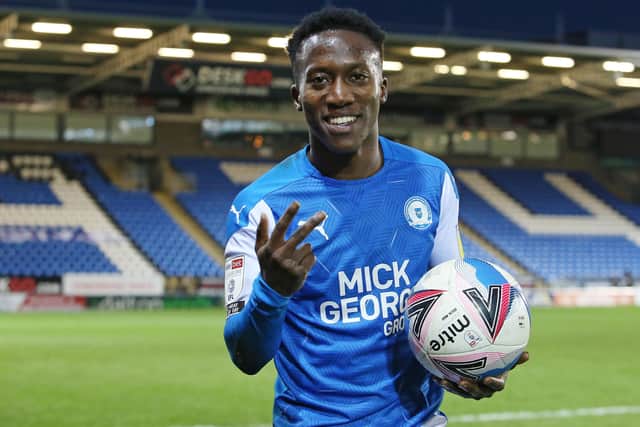 Siriki Dembele of Peterborough United celebrates at full-time with the match ball after scoring a hat-trick against Shrewsbury. Phot: Joe Dent/theposh.com.