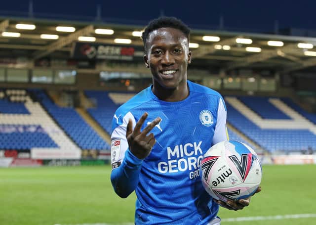 Siriki Dembele of Peterborough United celebrates at full-time with the match ball after scoring a hat-trick against Shrewsbury. Phot: Joe Dent/theposh.com.