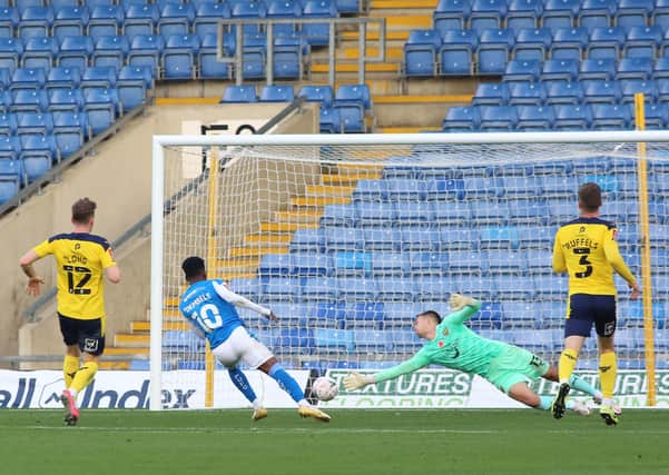 Siriki Dembele of Peterborough United scores the opening goal of the game  at Oxford. Photo: Joe Dent/theposh.com.