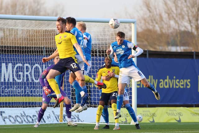 Jack Taylor of Peterborough United heads the ball clear from an Oxford United corner in the recent FA Cup tie. Photo: Joe Dent/theposh.com.