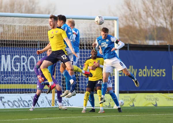 Jack Taylor of Peterborough United heads the ball clear from an Oxford United corner in the recent FA Cup tie. Photo: Joe Dent/theposh.com.