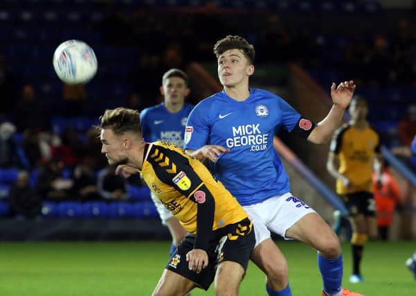 Harrison Burrows (blue) in action for Posh against Cambridge United in their last meeting in 2019.