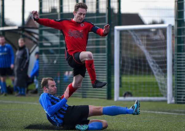Tommy Randall (red) has been scoring well for Netherton United in the Peterborough Premier Division.