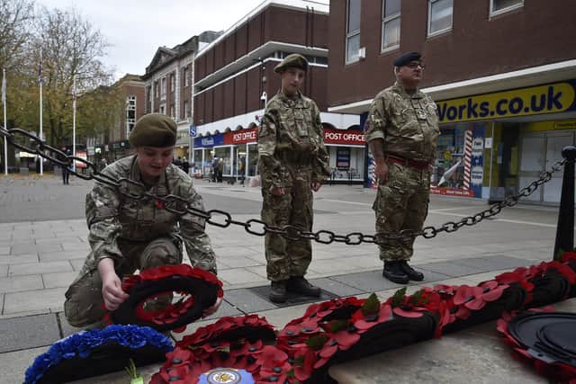 Army cadets Caitlin Ramm and Kyle Thompson-Parkinson with Lt Jon Blundell laying a wreath at the War Memorial at Bridge Street