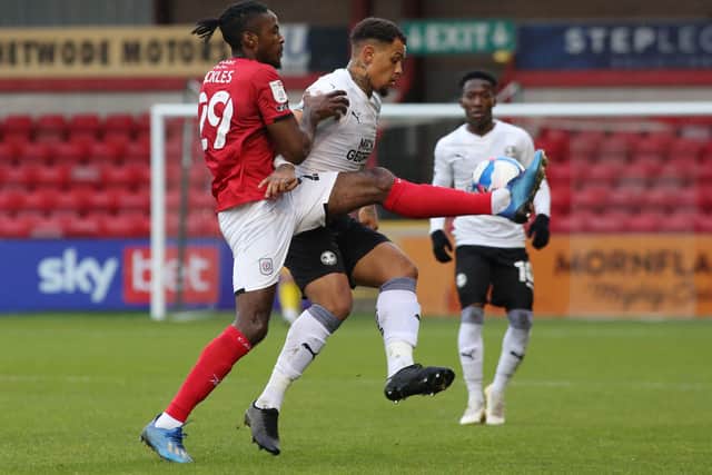 Jonson Clarke-Harris of Peterborough United battles with Omar Beckles of Crewe Alexandra. Photo: Joe Dent/theposh.com.