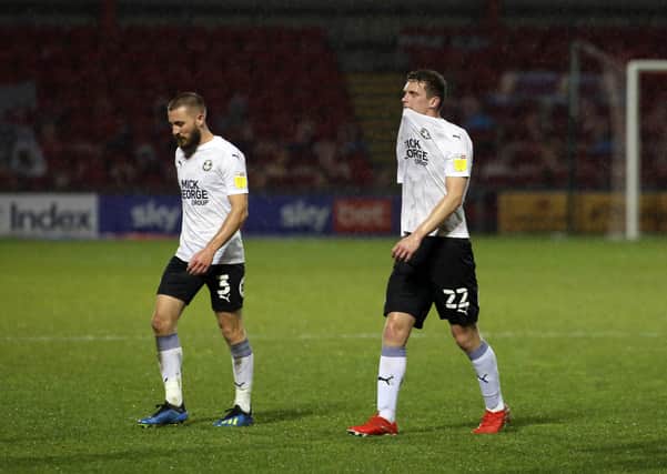 Ethan Hamilton of Peterborough United (right)  leaves the pitch dejected at full-time alongside Dan Butler. Photo: Joe Dent/theposh.com/