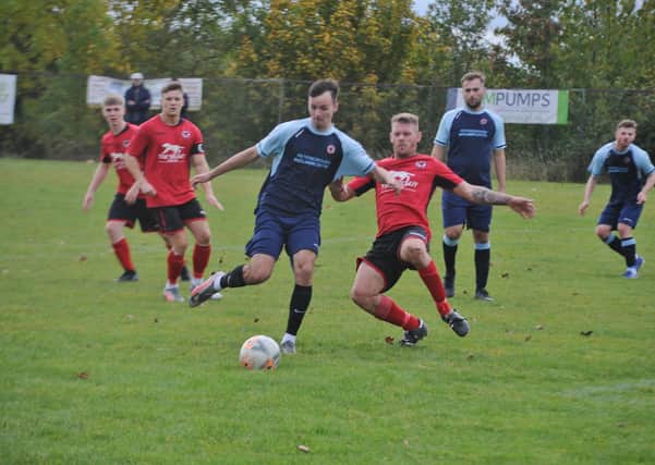 Action from the recent game between Stilton United (red) and Netherton United. Photo: David Lowndes.