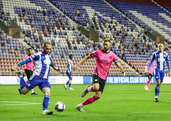 Mark Beevers (right) in action for Posh at Wigan.