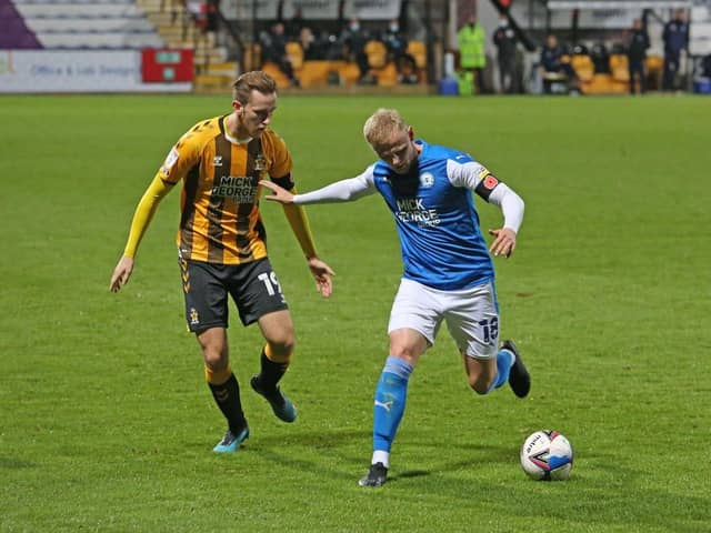 Frazer Blake-Tracy (blue) in action for Posh against Cambridge in the EFL Trophy earlier this month. Photo: Joe Dent/theposh.com.