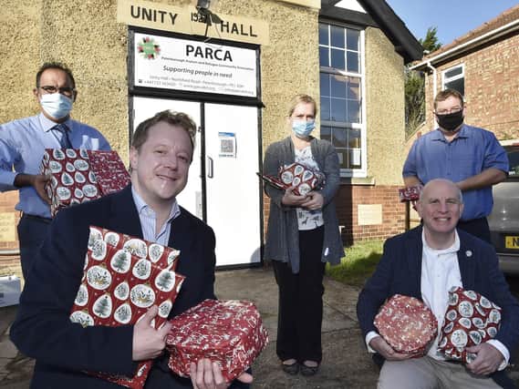 Paul Bristow MP and John Peach who donated presents to the launch of  the Peterborough Asylum and refugee Community Association childrens christmas appeal. They were received by Moez Nathu, Beth MacLellan and Mark Murray EMN-201211-152606009
