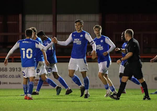 Charlie O'Connell (centre) takes the plaudits from his teammates after scoring for Posh Youths at Altrincham. Photo: Joe Dent/theposh.com.