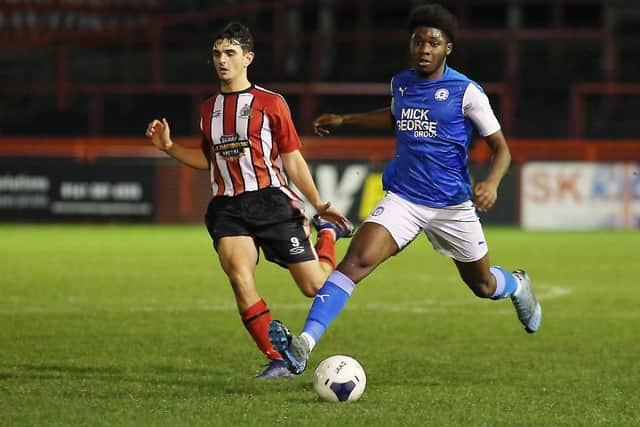 Dave Bodie (blue) in action for Posh Youths at Altrincham. Photo: Joe Dent/theposh.com.