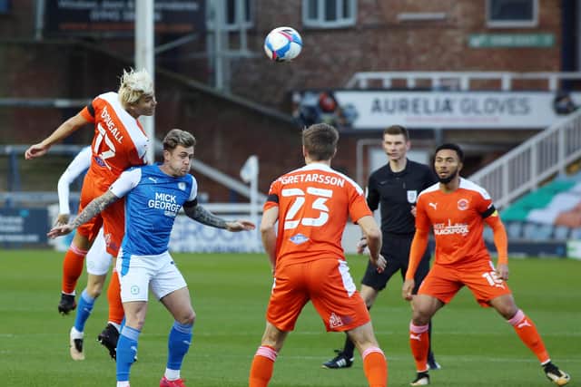 Sammie Szmodics of Peterborough United is challenged by Kenny Dougall of Blackpool. Photo: Joe Dent/theposh.com.