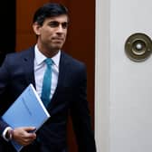 Britain's Chancellor of the Exchequer Rishi Sunak carries a copy of his Spending Review 2020 as he leaves 11 Downing Street in central London, on November 25, 2020, before heading to the House of Commons to present his economic spending review. (Photo by Tolga Akmen / AFP) (Photo by TOLGA AKMEN/AFP via Getty Images) YPN-201125-150950060
