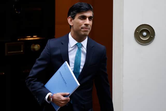 Britain's Chancellor of the Exchequer Rishi Sunak carries a copy of his Spending Review 2020 as he leaves 11 Downing Street in central London, on November 25, 2020, before heading to the House of Commons to present his economic spending review. (Photo by Tolga Akmen / AFP) (Photo by TOLGA AKMEN/AFP via Getty Images) YPN-201125-150950060