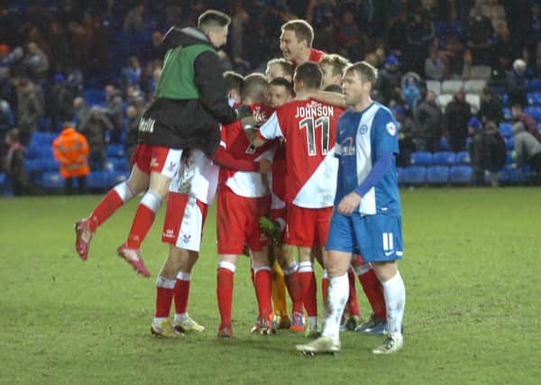 Compare the joy of the Kidderminster players with the despair of Posh skipper Grant McCann after an FA Cup shock in 2014.