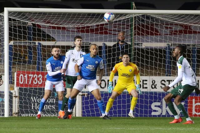 Christy Pym of Peterborough United keeps an eye on the ball as Plymouth Argyle attack. Photo: Joe Dent/theposh.com.
