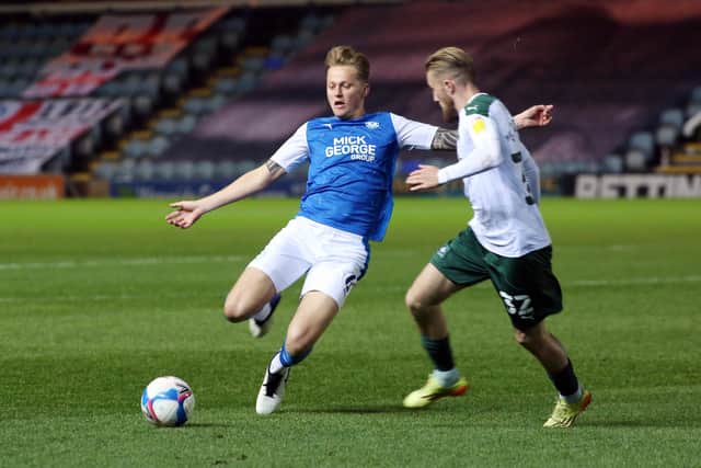 Frankie Kent of Peterborough United in action with George Cooper of Plymouth Argyle. Photo: Joe Dent/theposh.com.