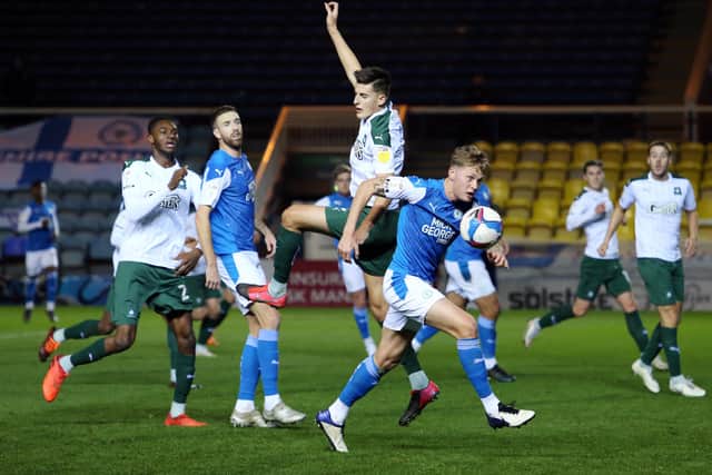 Frankie Kent of Peterborough United gets the ball away from Kelland Watts of Plymouth Argyle. Photo: Joe Dent/theposh.com.