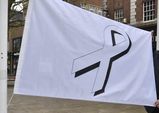 A White Ribbon flag was raised at the Town Hall at the start of a domestic abuse campaign this week.