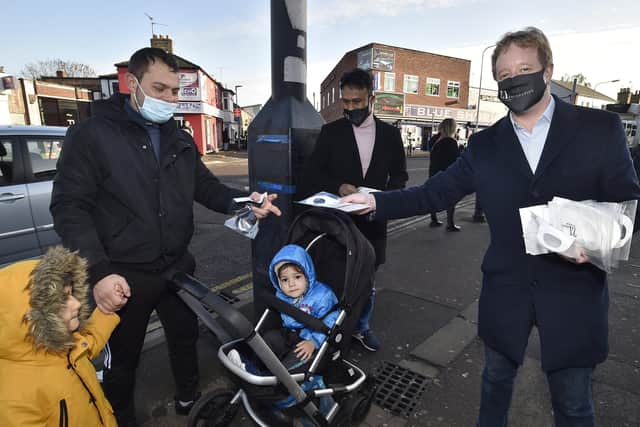 MP for Peterborough Paul Bristow with Zillur Hussain from the Zi Foundation handing out masks at Millfield following the announcement that Peterborough would enter Tier 2 restrictions after lockdown.