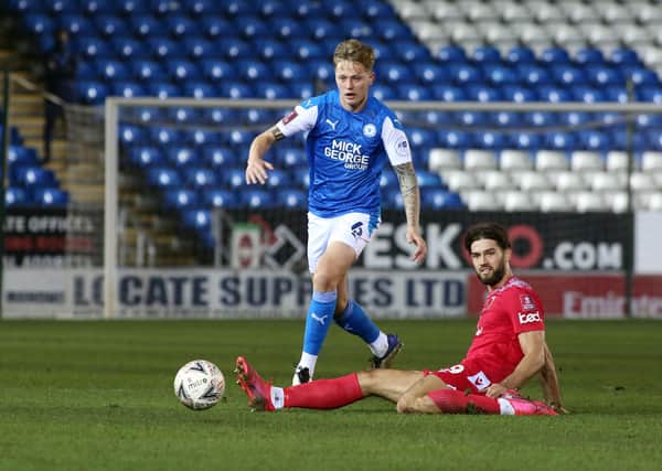 Frankie Kent of Peterborough United in action with Harry Cardwell of Chorley. Photo: Joe Dent/theposh.com.