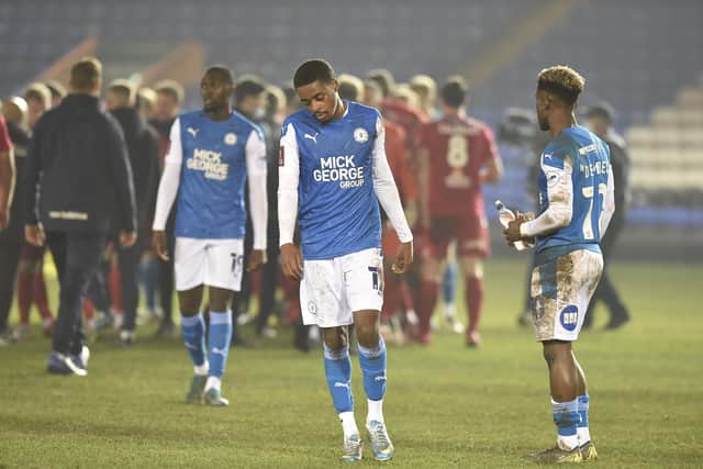 Posh players, from left, Idris Kanu, Reece Brown and Siriki Dembele troop off after their FA Cup defeat at the hands of Chorley.  Photo: David Lowndes.