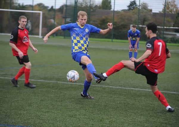 Action from the recent game between Netherton United (red) and Peterborough North End Sports.