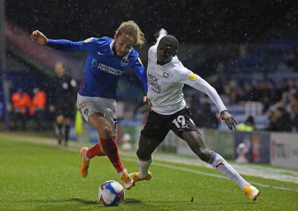 Idris Kanu of Peterborough United battles with Marcus Harness of Portsmouth. Photo: Joe Dent/theposh.com.