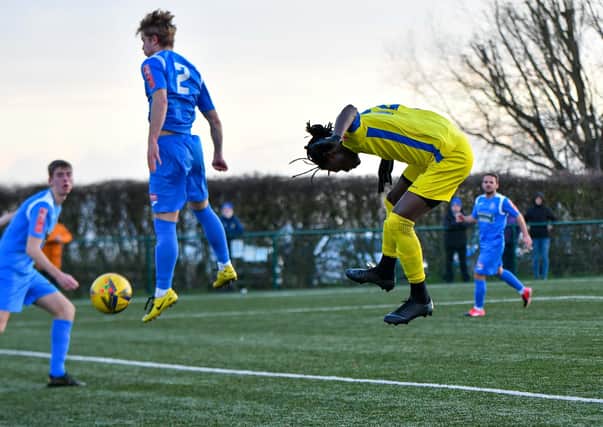 Maniche Sani (yellow) scores for Peterborough Sports against Yaxley. Photo: James Richardson.