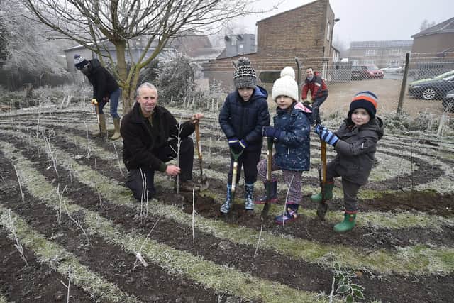 Tony Cook from PECT with volunteers planting a 'Tiny Forest' at Nene Valley Community Centre, Candy Street, Woodston