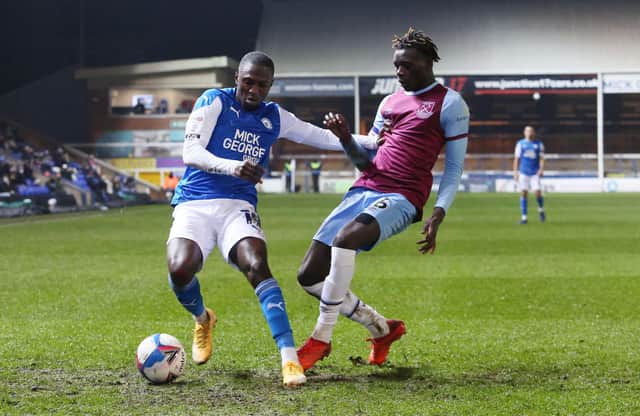 Idris Kanu of Peterborough United in action with Emmanuel Longelo of West Ham United. Photo: Joe Dent/theposh.com.
