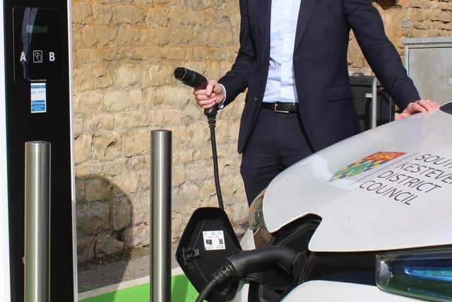SKDC Leader Coun Kelham Cooke testing out the car park charging points in Stamford. EMN-200912-131459001