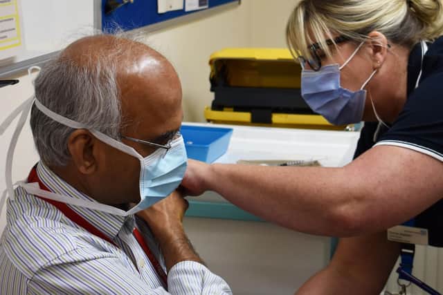 Northampton General Hospital consultant trauma and orthopaedic surgeon Rajan Natarajan gets his coronavirus jab. Photo: NGH
